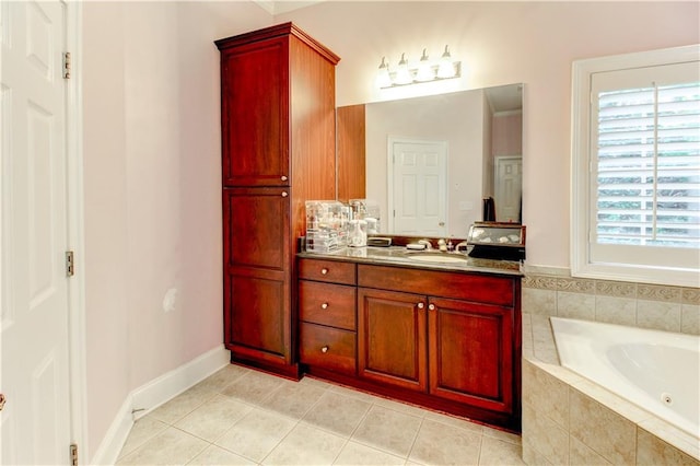 bathroom with tile patterned flooring, vanity, and tiled tub