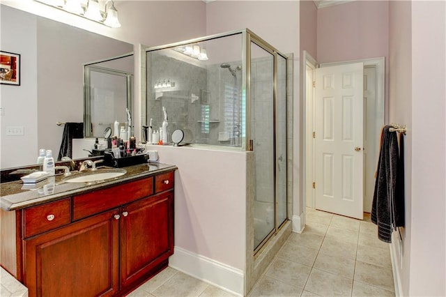 bathroom featuring tile patterned floors, vanity, and a shower with shower door