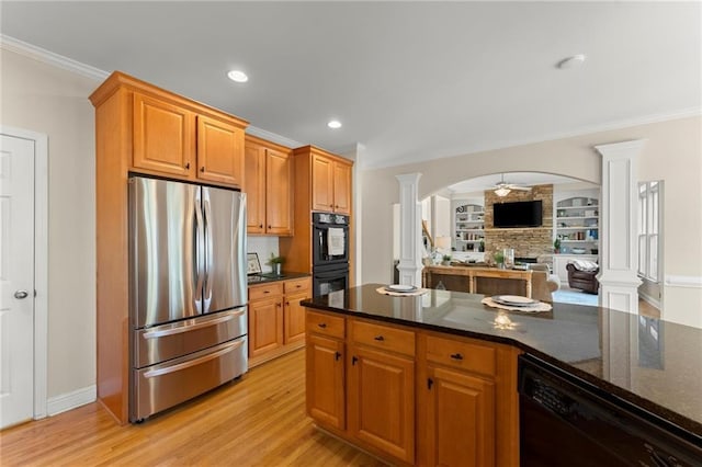 kitchen with black appliances, crown molding, and ornate columns