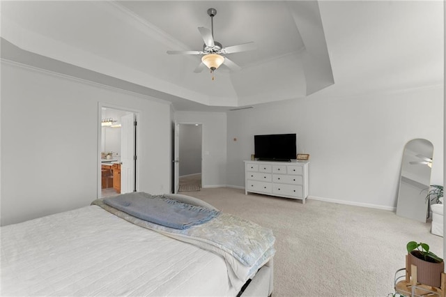 bedroom featuring a raised ceiling, crown molding, light colored carpet, and baseboards