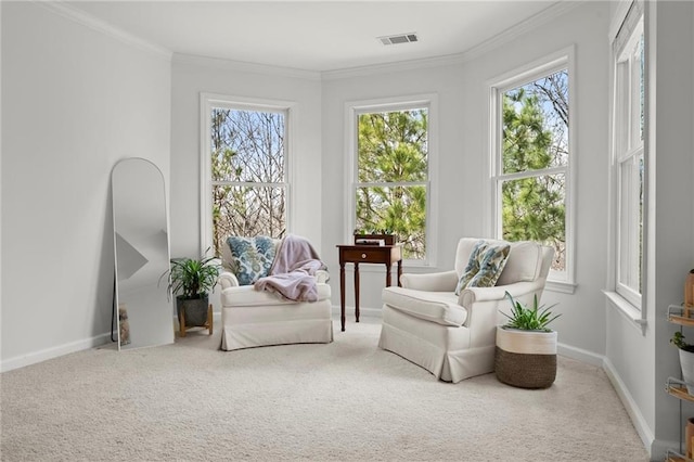 living area featuring visible vents, baseboards, carpet flooring, and crown molding