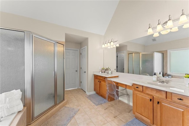 bathroom featuring vanity, baseboards, lofted ceiling, a stall shower, and tile patterned flooring