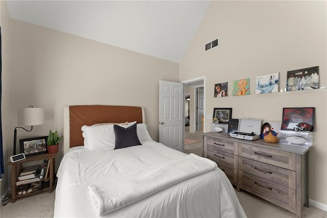 bedroom featuring high vaulted ceiling, baseboards, visible vents, and light carpet