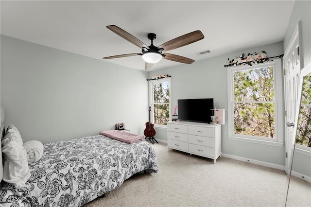 bedroom with visible vents, baseboards, and ceiling fan