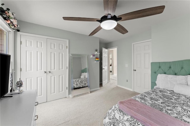 carpeted bedroom featuring baseboards, a closet, and ceiling fan