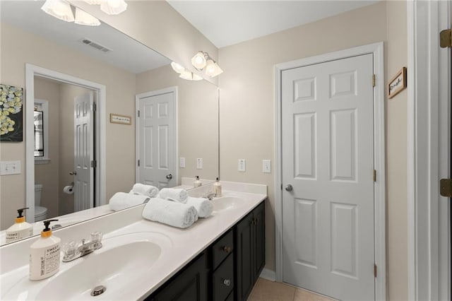 full bath featuring tile patterned flooring, double vanity, visible vents, and a sink