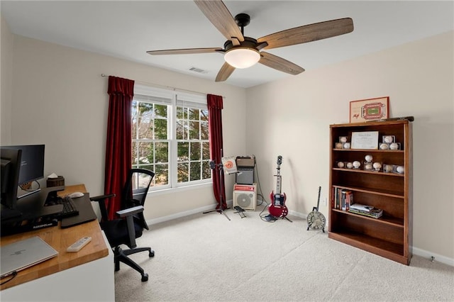 office area featuring visible vents, carpet flooring, a ceiling fan, and baseboards