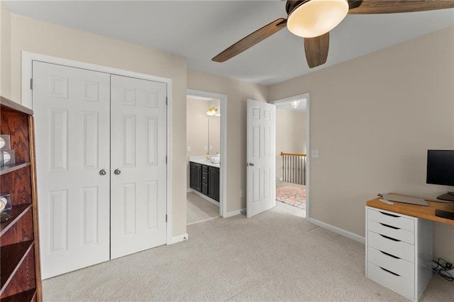 office with light carpet, a ceiling fan, and baseboards