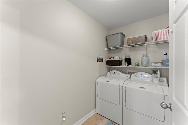 laundry room featuring laundry area, baseboards, and separate washer and dryer