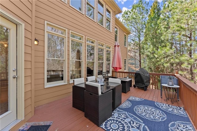 wooden deck featuring grilling area and an outdoor hangout area