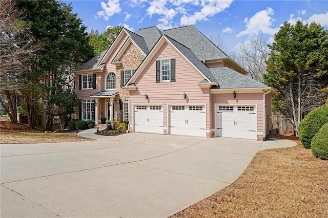 view of front facade with a garage, stone siding, roof with shingles, and driveway