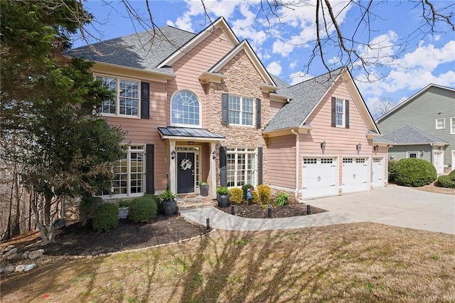 view of front of home with a garage, stone siding, driveway, and a shingled roof