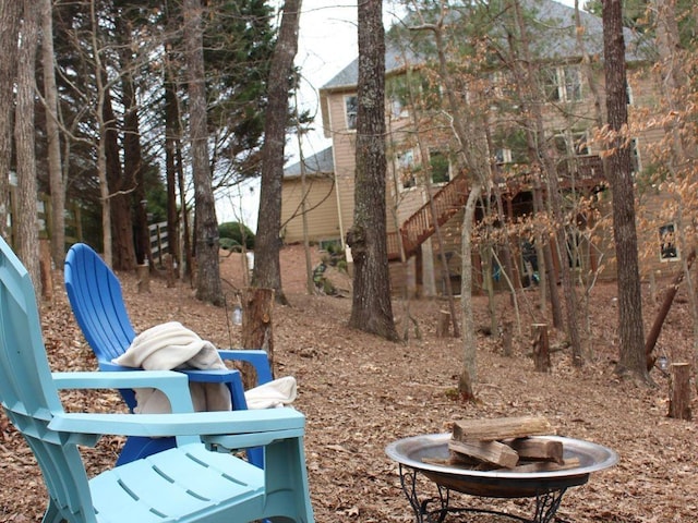 view of yard with stairway and a fire pit