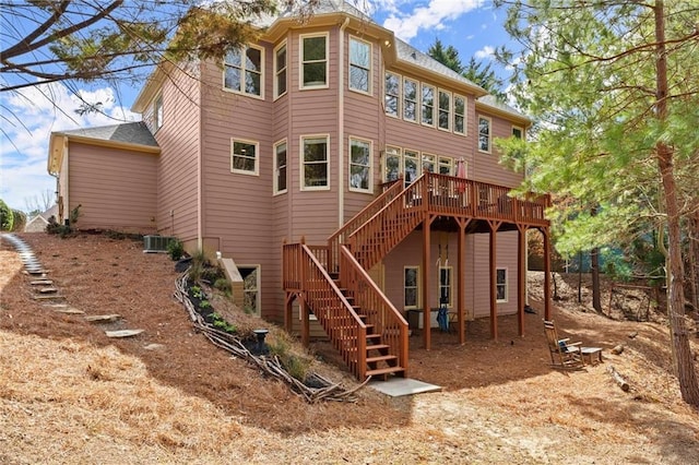 back of property with cooling unit, stairs, and a deck