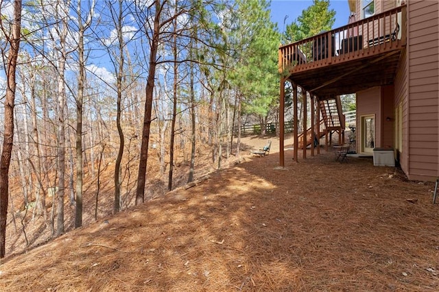 view of yard featuring a deck and stairway