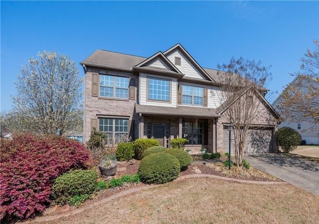 view of front of house featuring a front lawn, a garage, and a porch