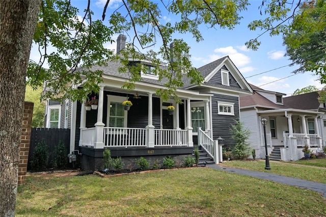 view of front of property with a front yard and a porch