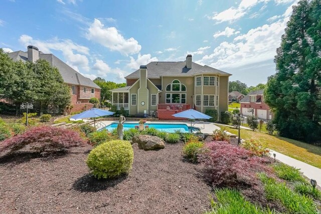 2439 Huntington Park Dr NW, Acworth, GA 30101 - back of property with a patio, a chimney, an outdoor pool, and a deck