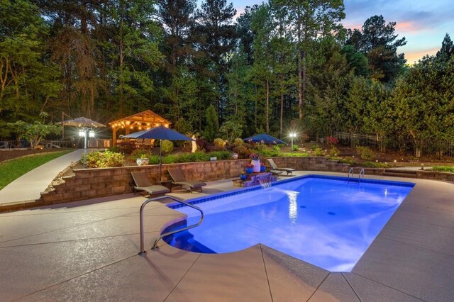 2439 Huntington Park Dr NW, Acworth, GA 30101 - pool at dusk with a patio area and an outdoor pool
