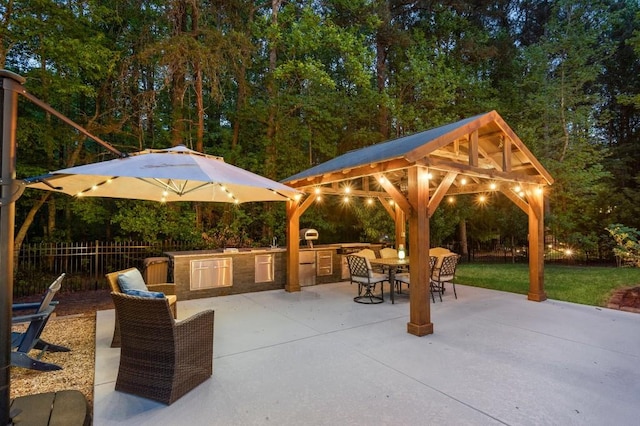 2439 Huntington Park Dr NW, Acworth, GA 30101 - view of patio / terrace with exterior kitchen, a gazebo, fence, and outdoor dining area