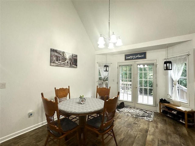 dining space featuring high vaulted ceiling, a notable chandelier, dark hardwood / wood-style flooring, and french doors