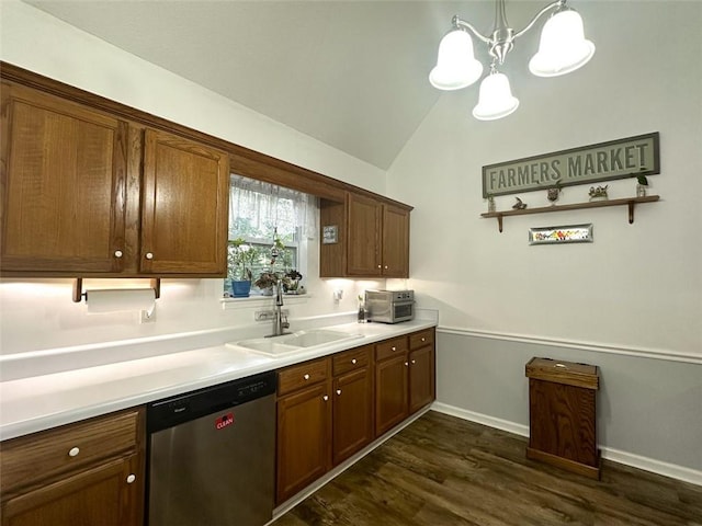 kitchen with lofted ceiling, sink, dark hardwood / wood-style flooring, decorative light fixtures, and stainless steel dishwasher