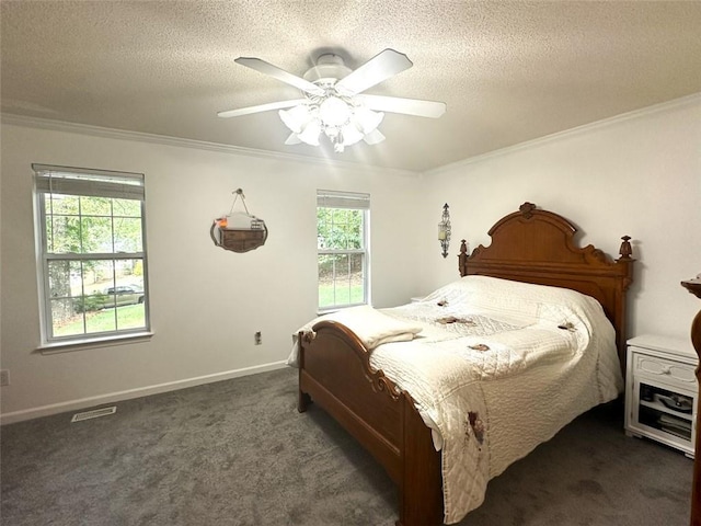 bedroom with crown molding, dark carpet, ceiling fan, and a textured ceiling