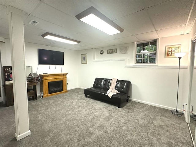 carpeted living room featuring a paneled ceiling