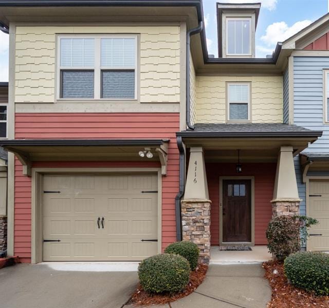 property entrance with a garage and driveway