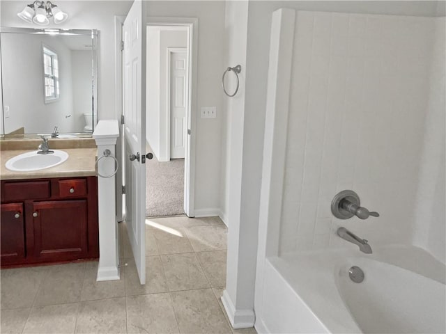 bathroom with tile patterned flooring, bathtub / shower combination, vanity, and baseboards