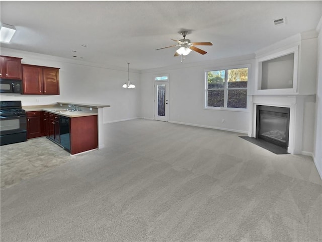 kitchen featuring reddish brown cabinets, black appliances, light countertops, and open floor plan