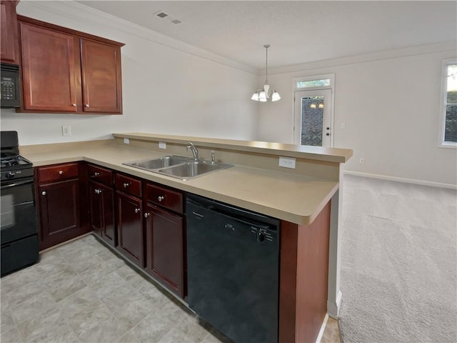 kitchen with a peninsula, a sink, light countertops, ornamental molding, and black appliances