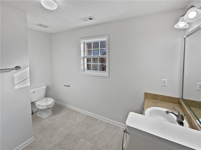 bathroom featuring toilet, baseboards, and visible vents