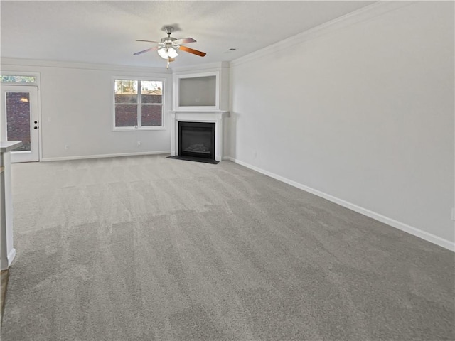 unfurnished living room with ceiling fan, ornamental molding, and light colored carpet