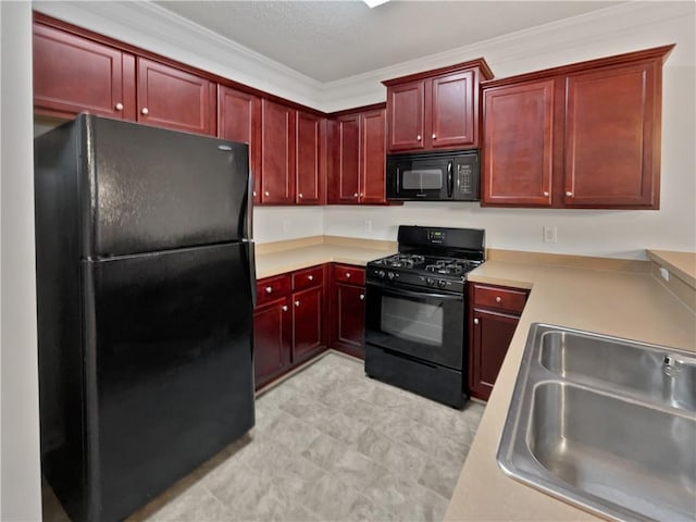 kitchen featuring reddish brown cabinets, black appliances, a sink, and light countertops