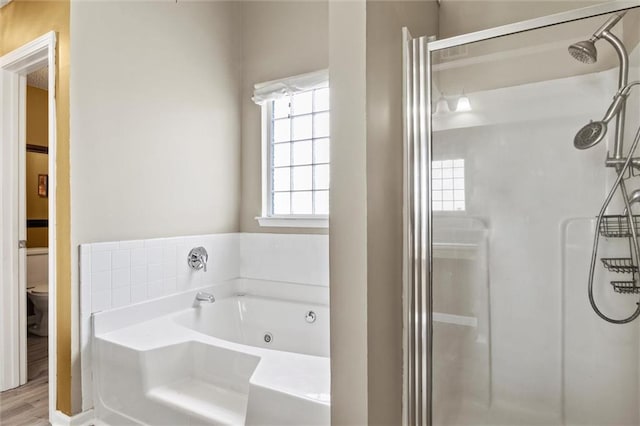 bathroom with toilet, independent shower and bath, and wood-type flooring