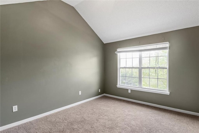 spare room with lofted ceiling and carpet floors