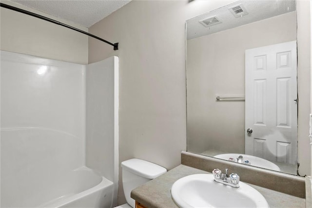 full bathroom featuring vanity, shower / washtub combination, a textured ceiling, and toilet