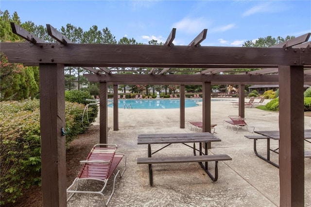 view of property's community featuring a pool, a patio, and a pergola