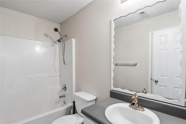 full bathroom with toilet, bathtub / shower combination, a textured ceiling, and vanity