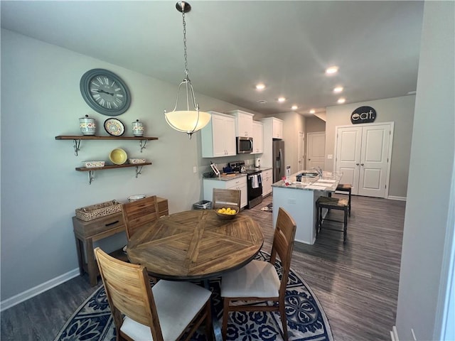 dining room with dark wood-type flooring and sink