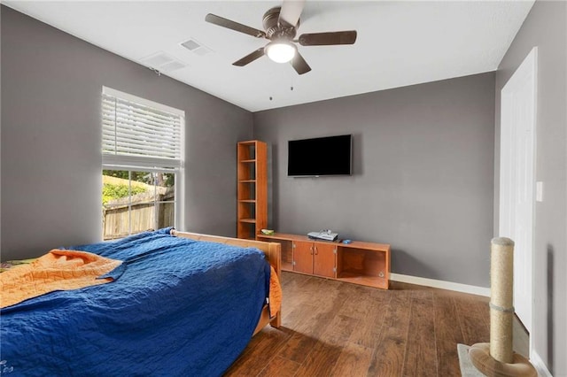 bedroom with wood finished floors, ceiling fan, and baseboards