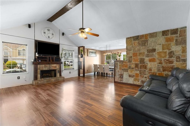 living room with a ceiling fan, a fireplace, wood finished floors, beam ceiling, and high vaulted ceiling