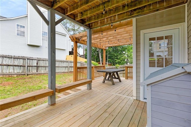 wooden terrace featuring fence