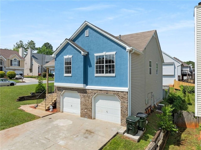 view of side of home with an attached garage, driveway, stucco siding, and brick siding