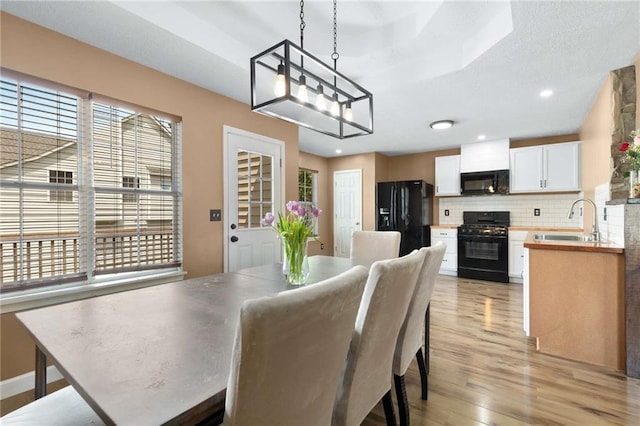 dining space featuring light wood-style floors and recessed lighting