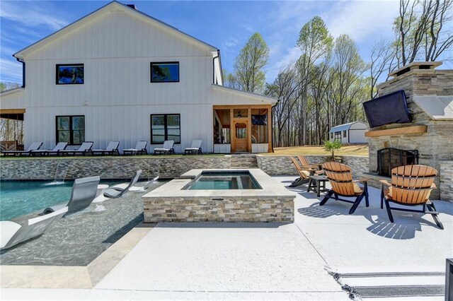 132 Swift Creek Way, Jefferson, GA 30549 - rear view of property featuring an outdoor stone fireplace, a patio area, and a pool with hot tub