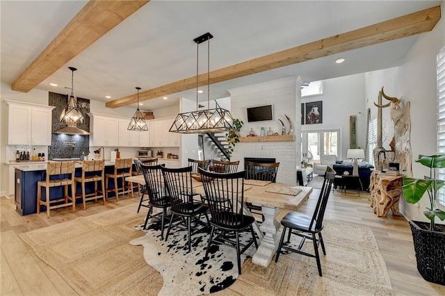 132 Swift Creek Way, Jefferson, GA 30549 - dining area with beamed ceiling, light wood-type flooring, and a brick fireplace