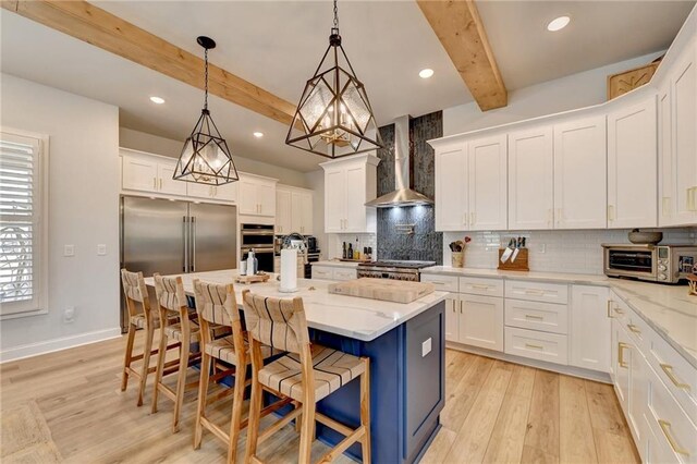 132 Swift Creek Way, Jefferson, GA 30549 - kitchen with a kitchen bar, wall chimney exhaust hood, beam ceiling, a center island with sink, and white cabinets