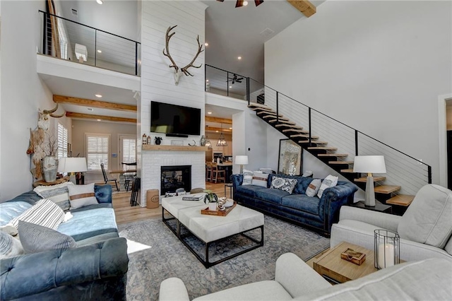 132 Swift Creek Way, Jefferson, GA 30549 - living room with a fireplace, a towering ceiling, hardwood / wood-style flooring, and ceiling fan